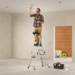 man-using-stepladder-Hailo-TL100-TopLine-Telescopic-Stepladder